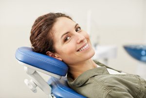 Portrait of smiling young woman lying in dental chair